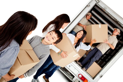 Professional house removals in Acton with a moving van and packed boxes