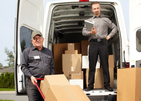 A moving team loading boxes safely into a van