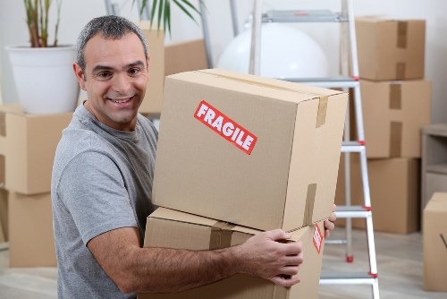 Students packing boxes for removals in Acton