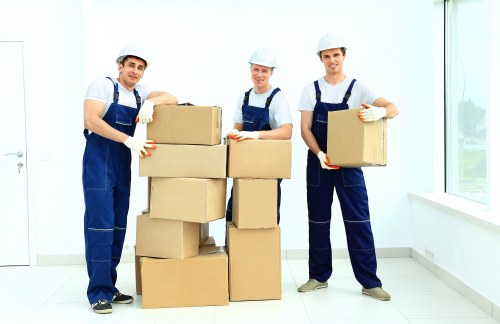Professional movers navigating a property in Acton with furniture