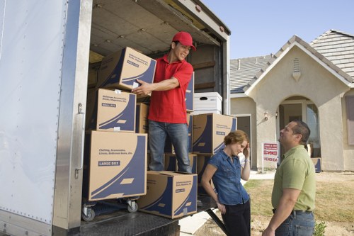 Packed boxes and furniture loaded for an Acton move