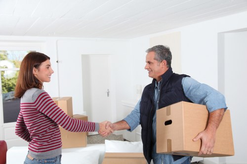 Trained removals staff handling furniture carefully during an Acton move