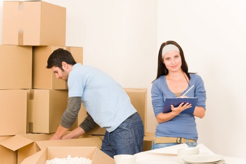 Packing boxes and furniture into a moving truck in Acton