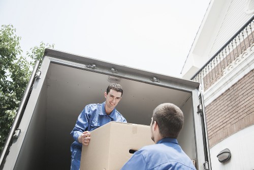 Trained moving staff using proper lifting techniques during a van job